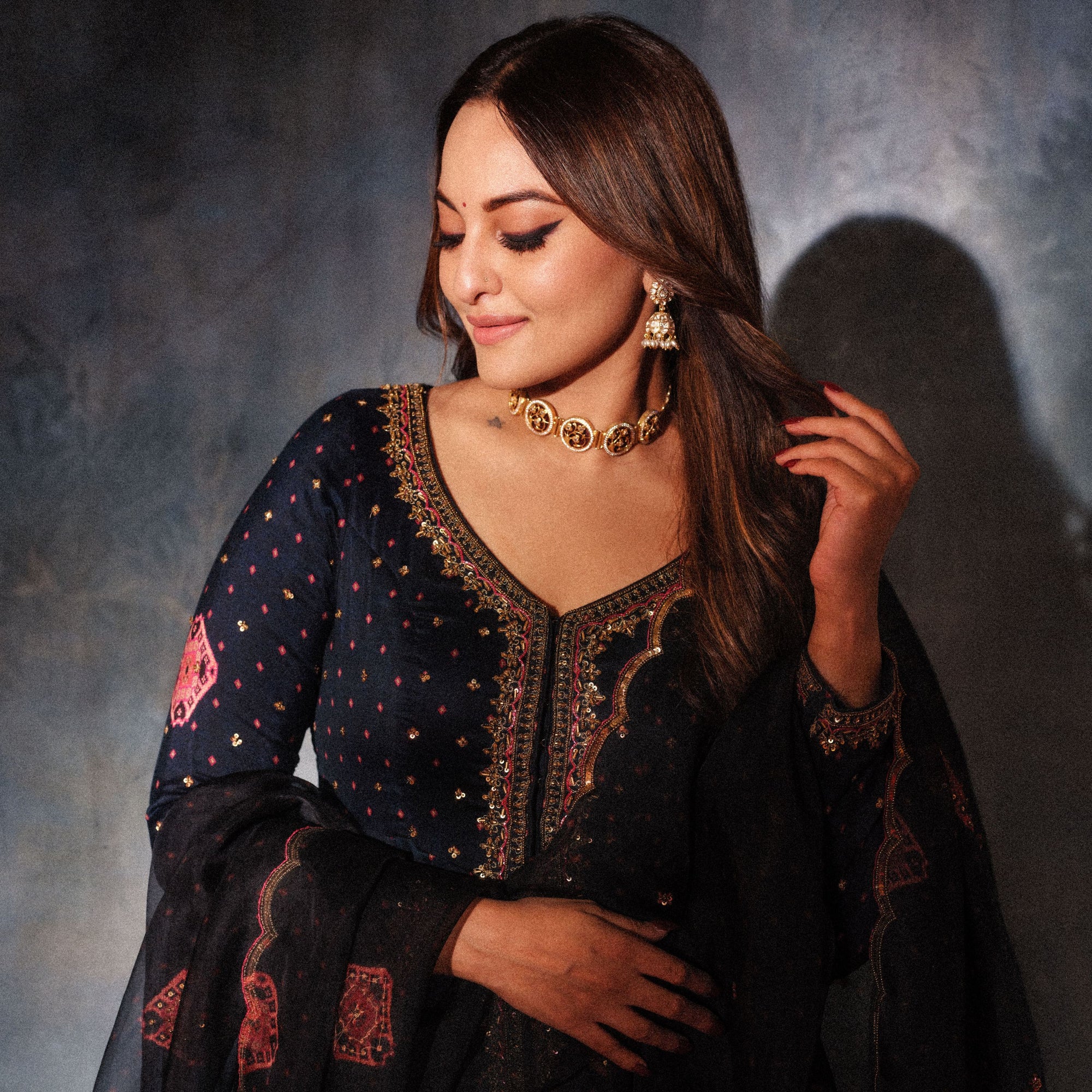 Sonakshi Sinha flaunting our Gold-plated silver choker necklace featuring coin-shaped pendants with Art Deco flora and fauna designs studded with CZ stones and black enamel.