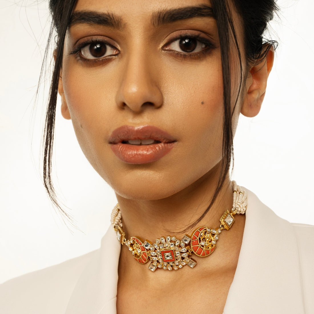 Polki-style choker necklace featuring coral-colored stones in a moon pattern and a centerpiece with coral and square-shaped polki stones.