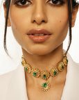 Gold-plated choker necklace featuring round emerald green stones arranged in a sunflower pattern.