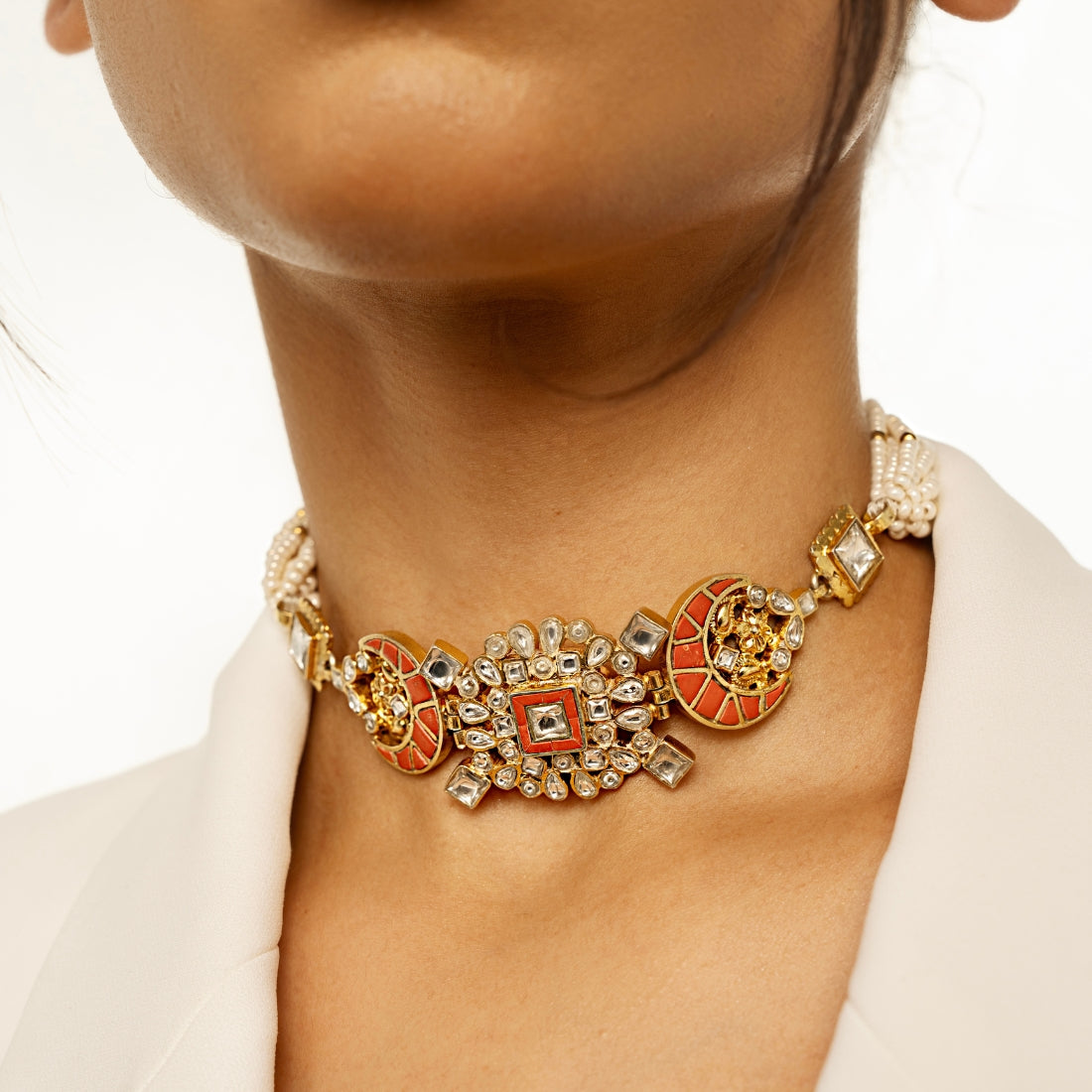 Polki-style choker necklace featuring coral-colored stones in a moon pattern and a centerpiece with coral and square-shaped polki stones.