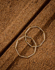 Set of two silver bangles featuring a two-tone finish with gold-plated rings and a unique octagonal shape.