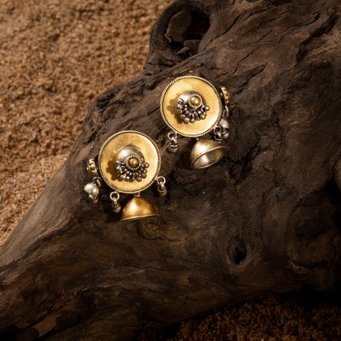 Two-tone jhumki earrings featuring a gold-plated stud with cascading beads and a silver tine jhumki with bead details.