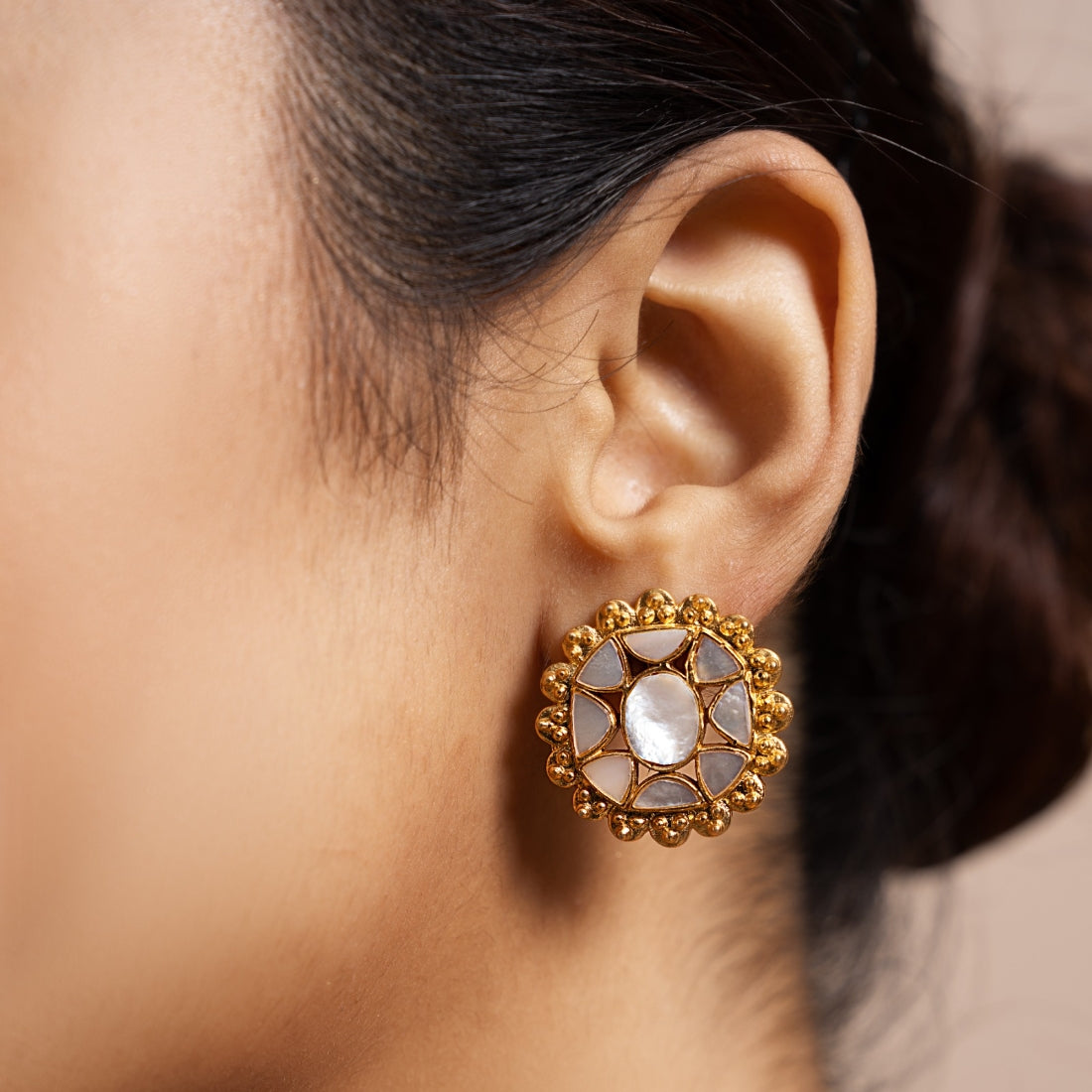 Geometric stud earrings featuring mother-of-pearl with an iridescent finish.