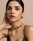 Gold-plated silver choker necklace and earrings set featuring coin-shaped pendants with art deco flora and fauna designs studded with CZ stones and black enamel.