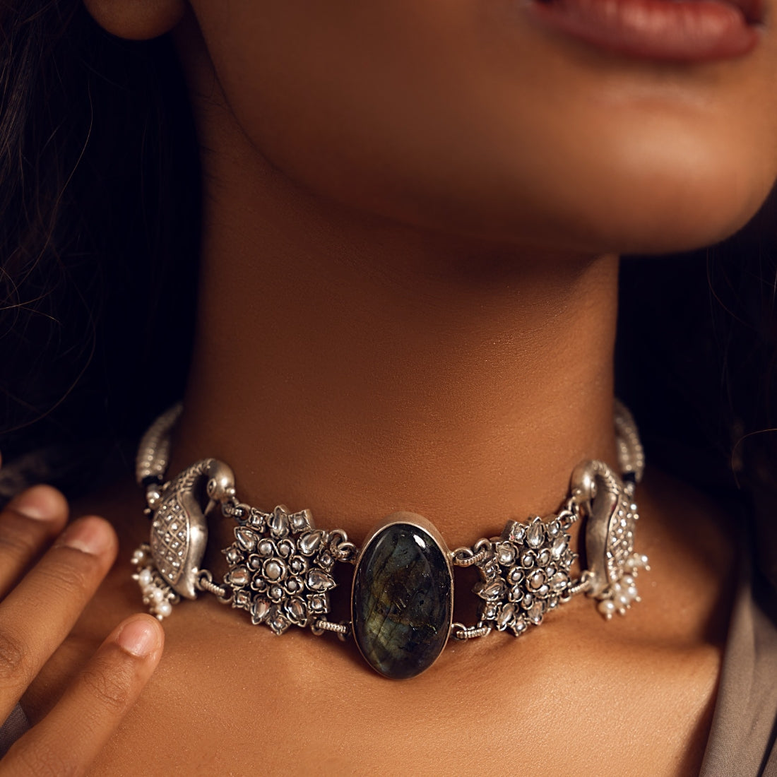 Oxidized silver choker necklace featuring a peacock motif with semi-precious stone accents.