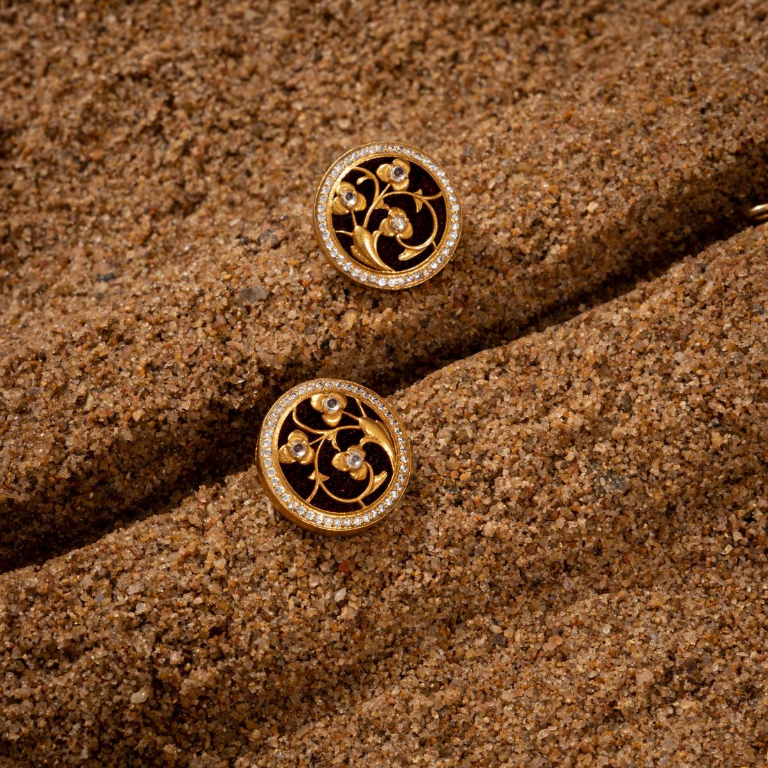 Silver choker necklace and stud earrings set featuring gold plating. The choker has coin-shaped pendants with Art Deco flora and fauna designs studded with CZ stones and black enamel.