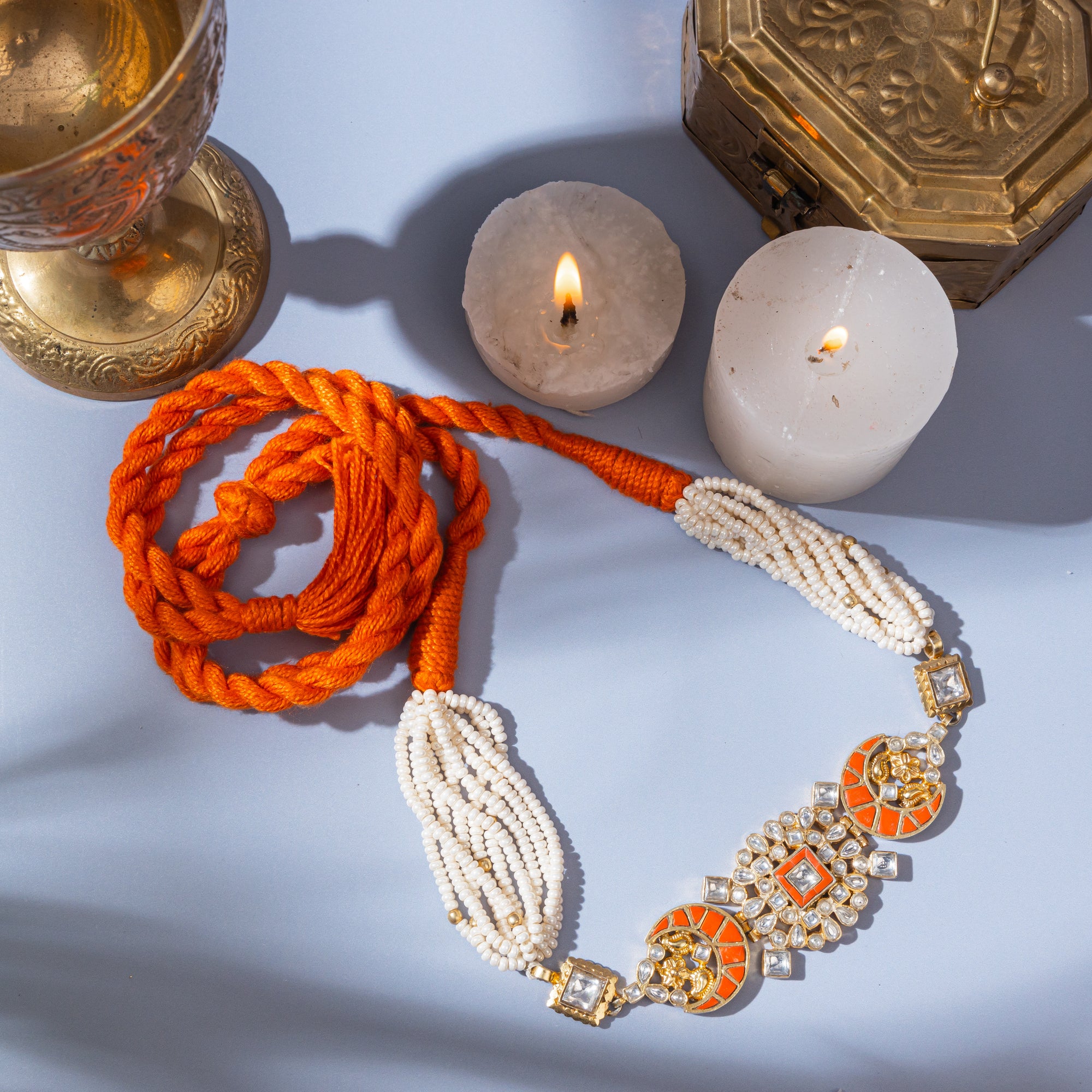 Polki-style choker necklace featuring coral-colored stones in a moon pattern and a centerpiece with coral and square-shaped polki stones.