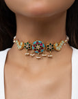 Gold-plated choker featuring colorful floral and peacock motifs with adjustable sizing and pearl strands on both sides.