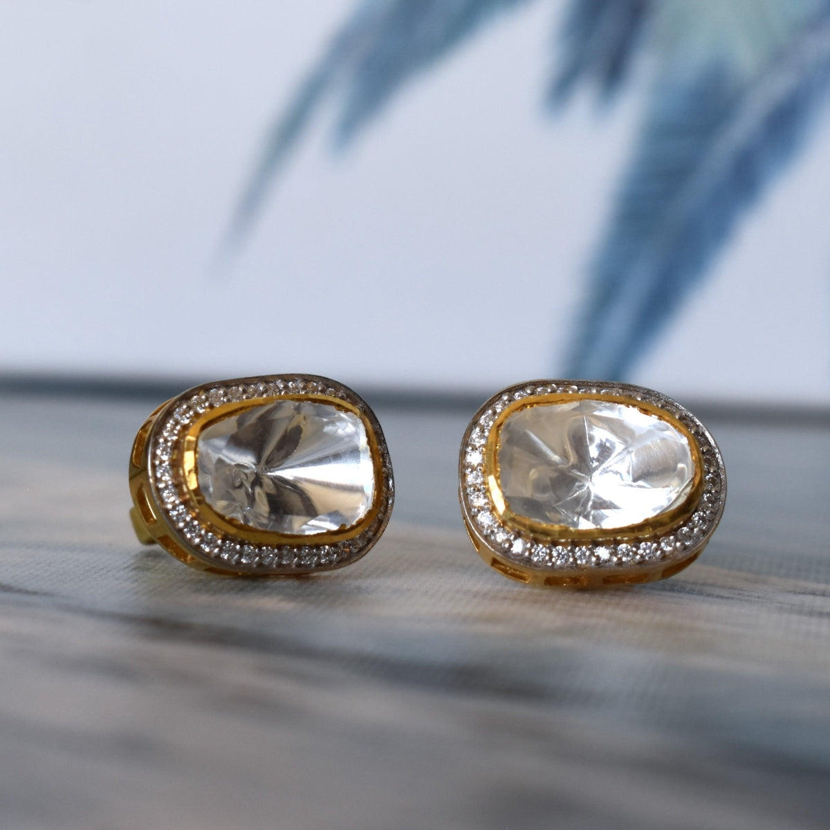 Sterling silver 925 stud earrings featuring a large moissanite stone surrounded by CZ stones.