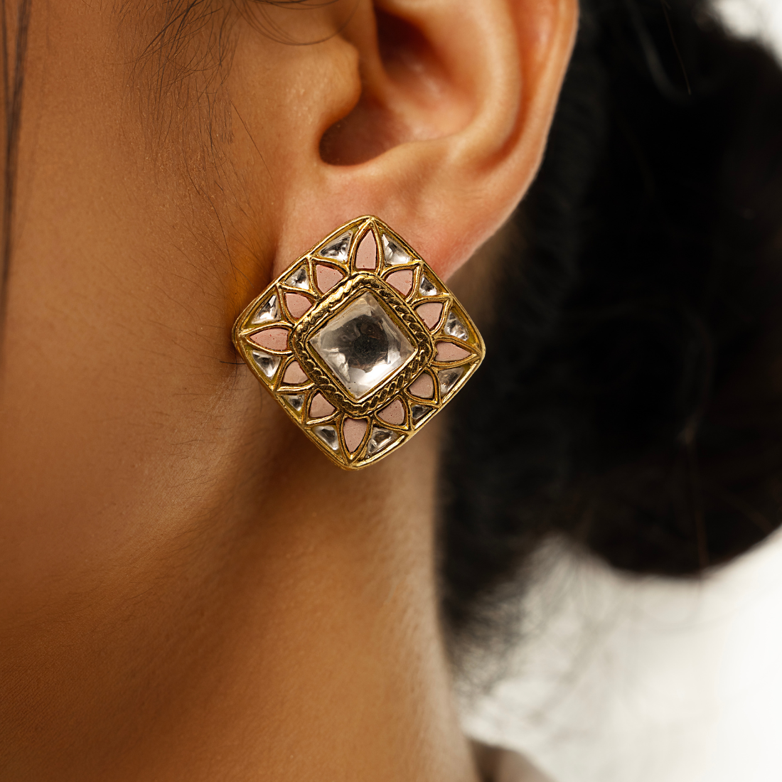 Silver stud earrings featuring a large central polki stone surrounded by smaller polkis and pastel pink stones in a delicate floral pattern. The polki stones have gold plating.